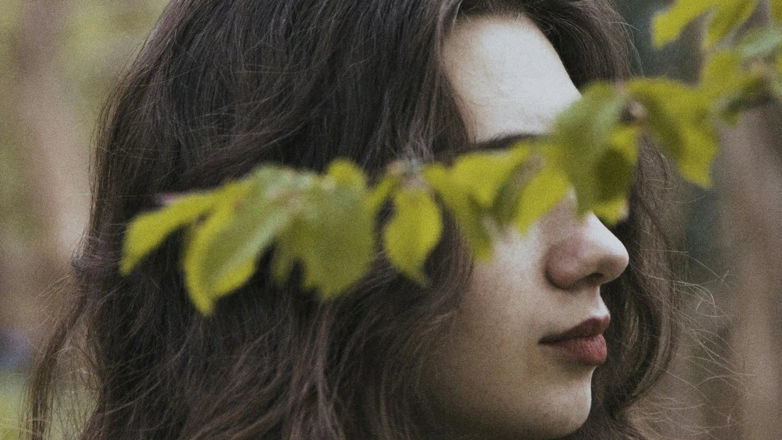 For the "sticky floor concept for women at work" article, a side profile of a woman's face with long brown hair and a branch with leaves covering her eyes