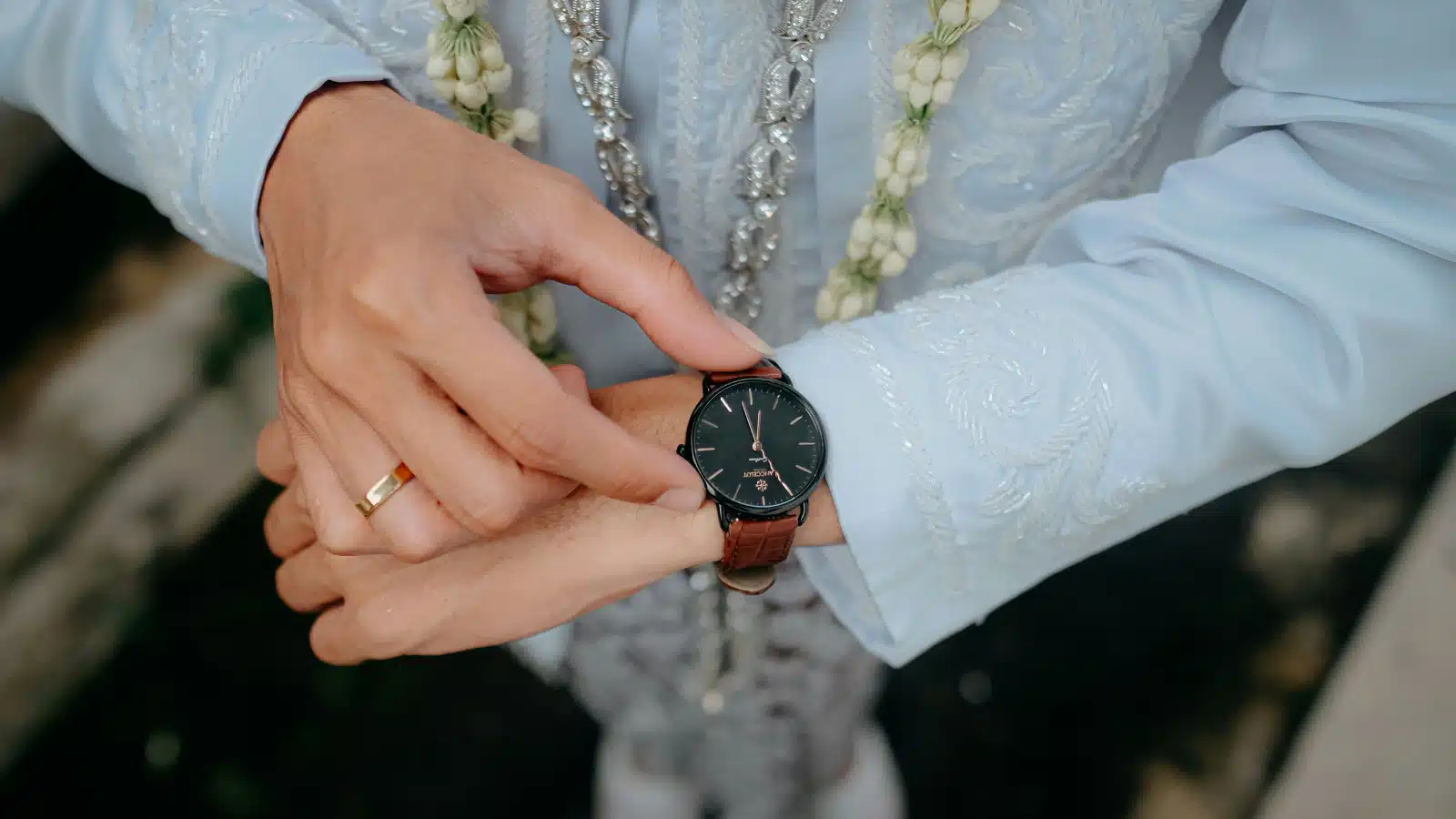 For the "how to get your focus back" article, a close up of a woman's hands in a blue blouse checking the time on her watch